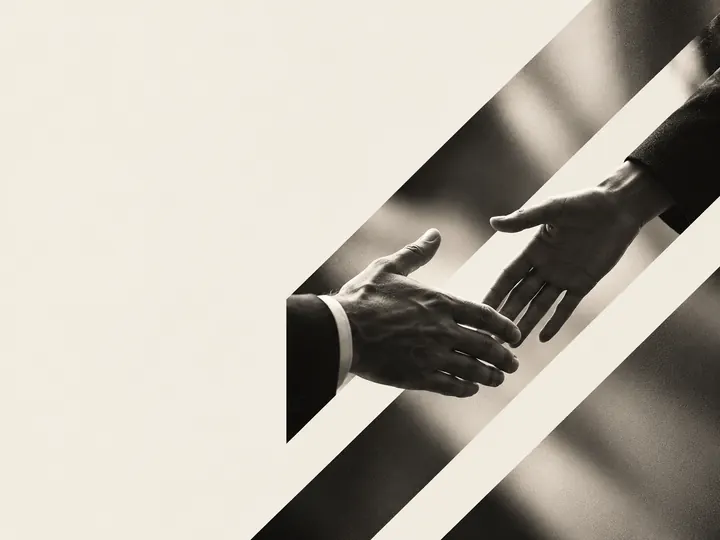 Two hands about to shake, in black and white, crossed by diagonal stripes.